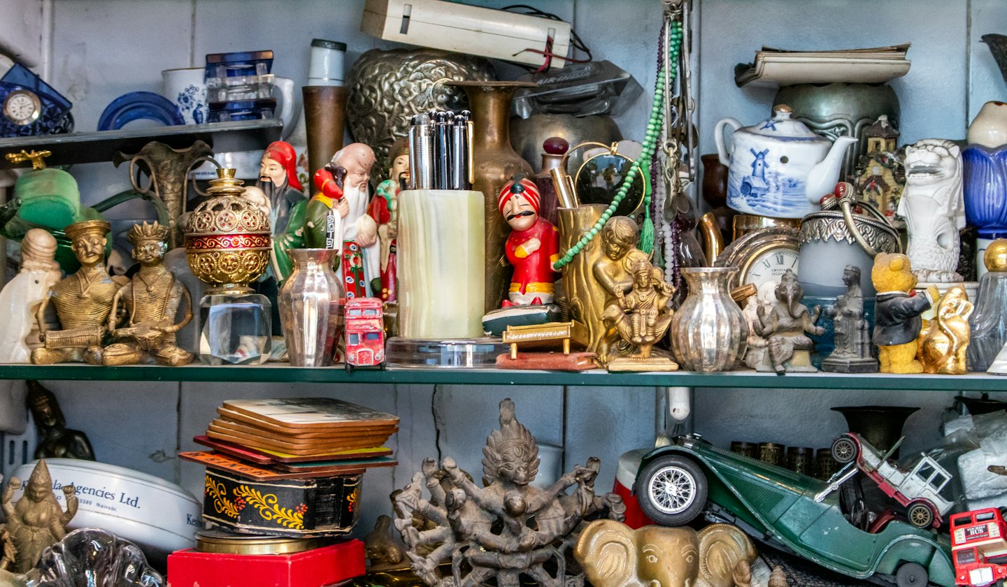 Many vintage collectible items displayed on glass shelves.