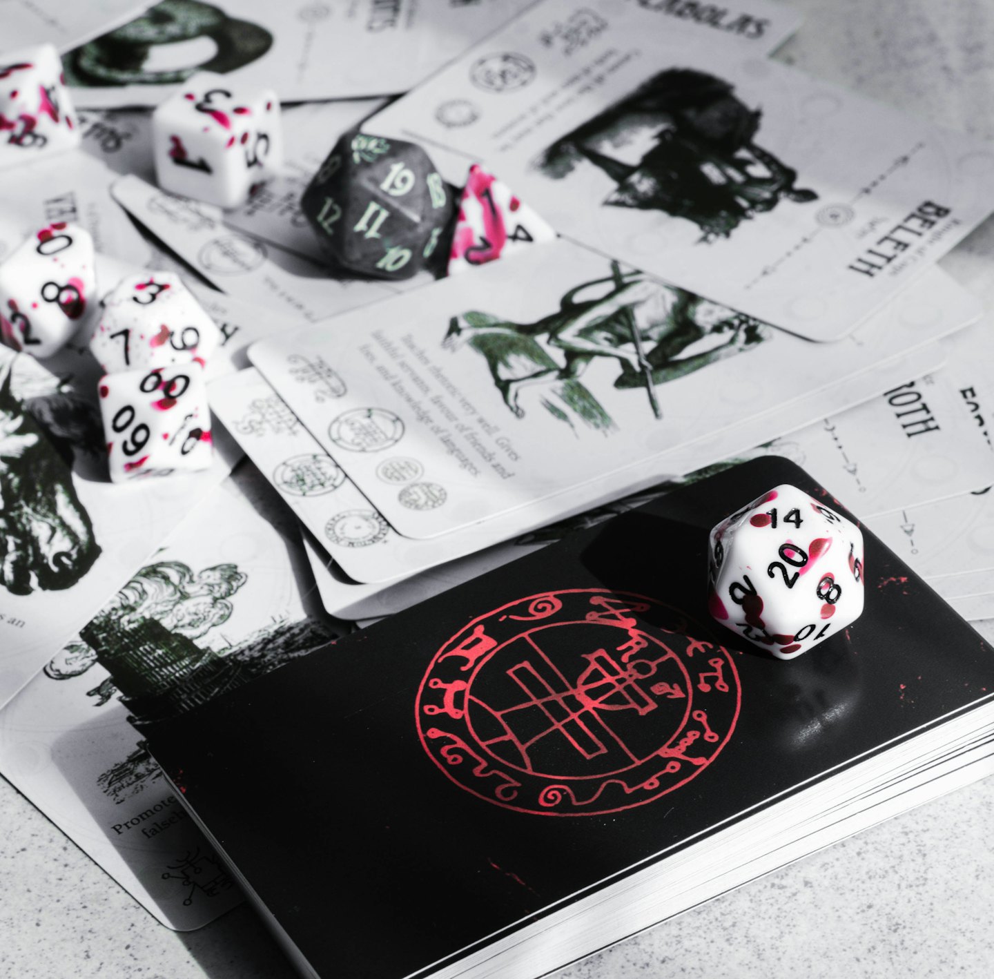 Polyhedral dice and occult cards scattered on a table.
