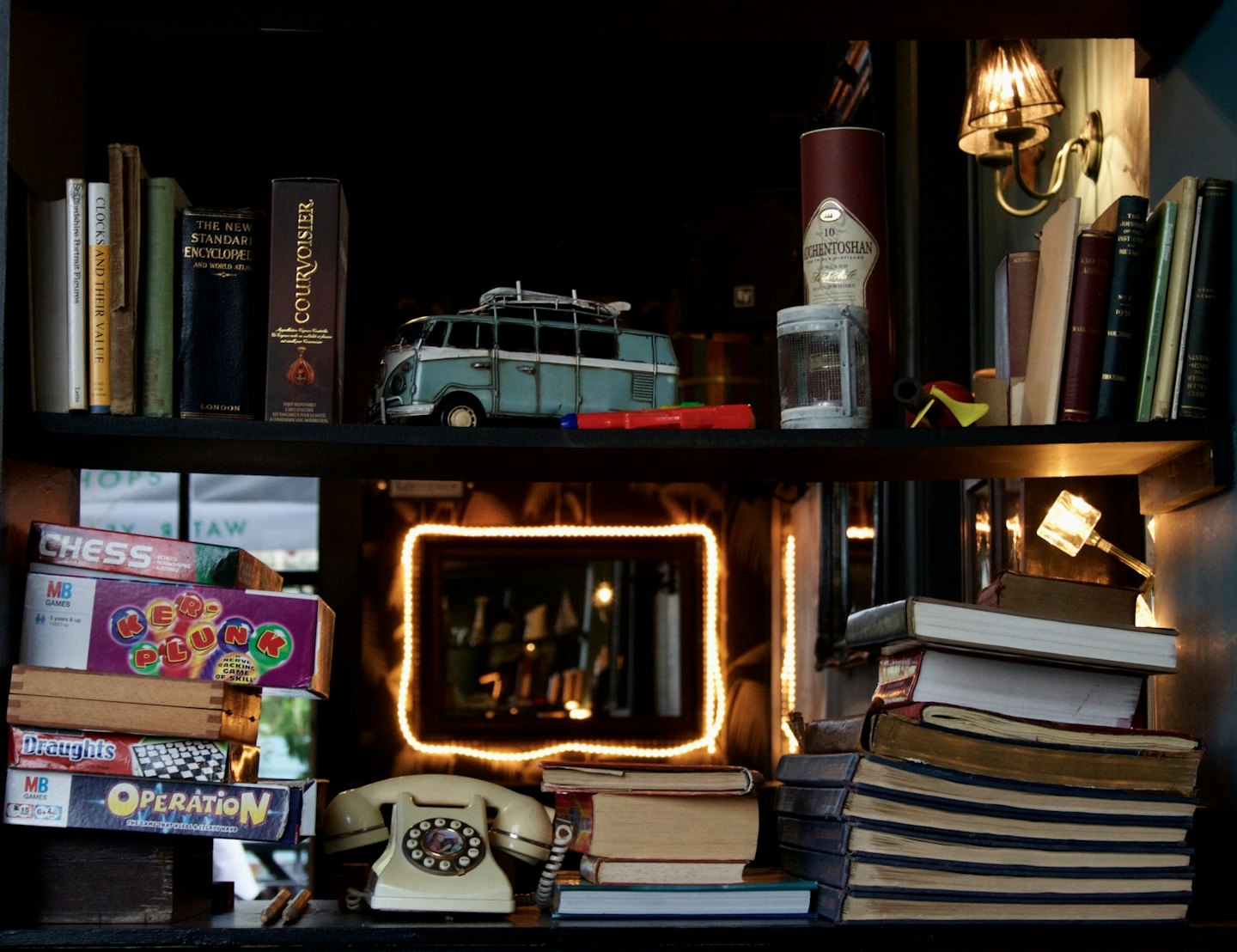 Vintage items displayed on dark wooden shelves.