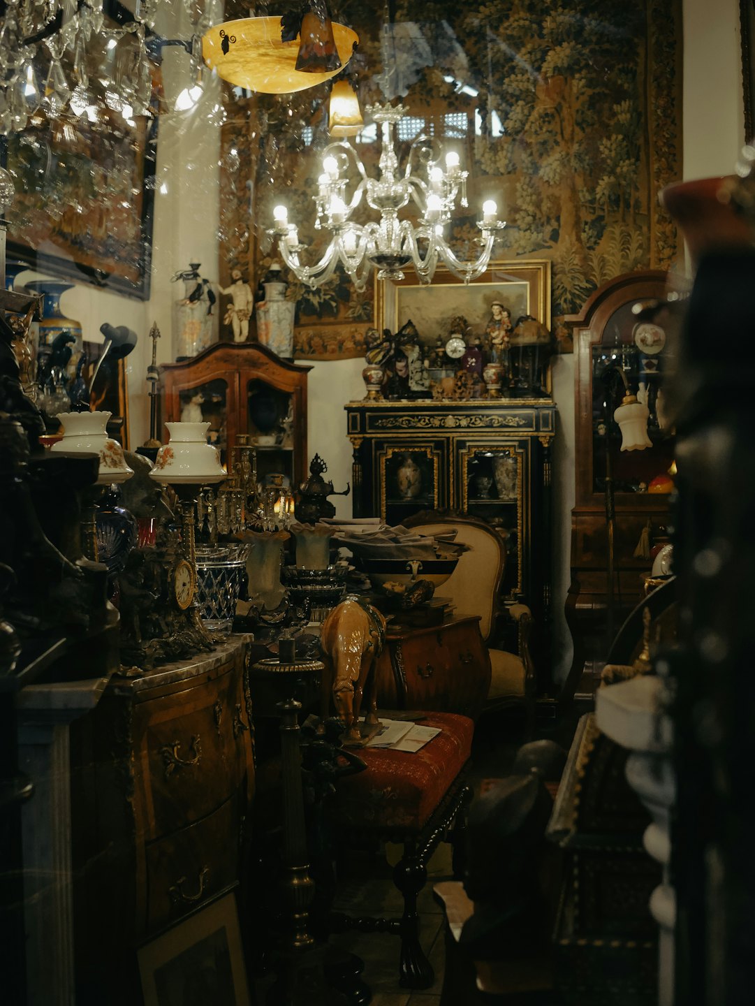Antique shop filled with vintage furniture and glass chandeliers.
