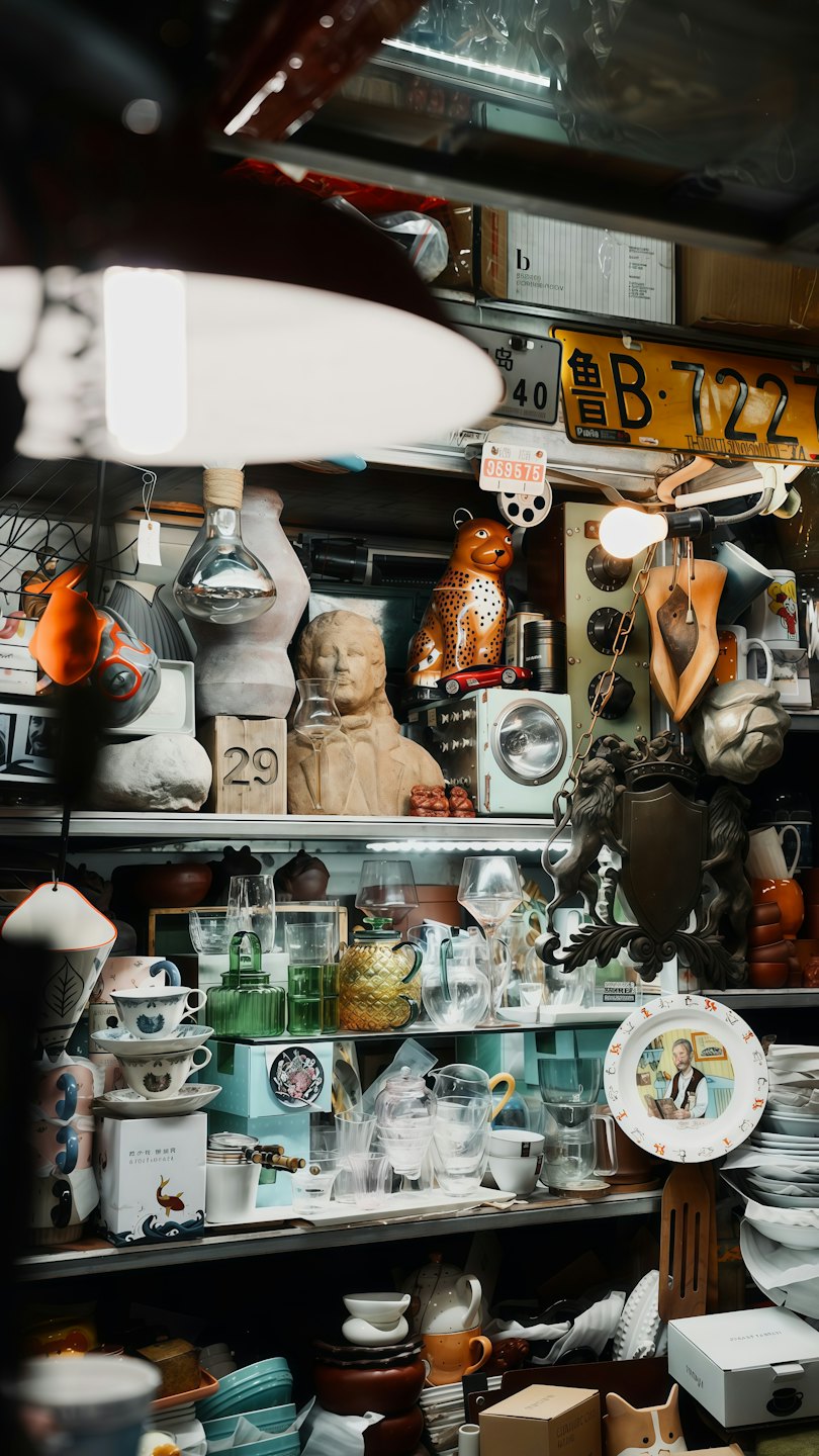 Shelf full of eclectic vintage items in a shop.