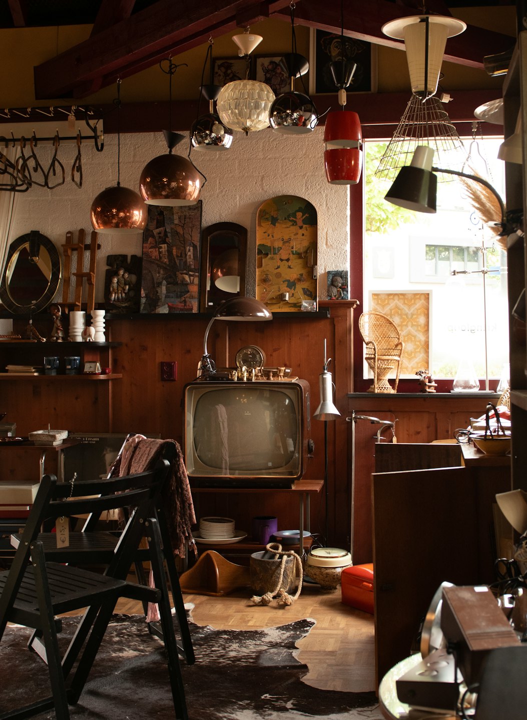Cluttered vintage shop filled with antique furniture and objects.