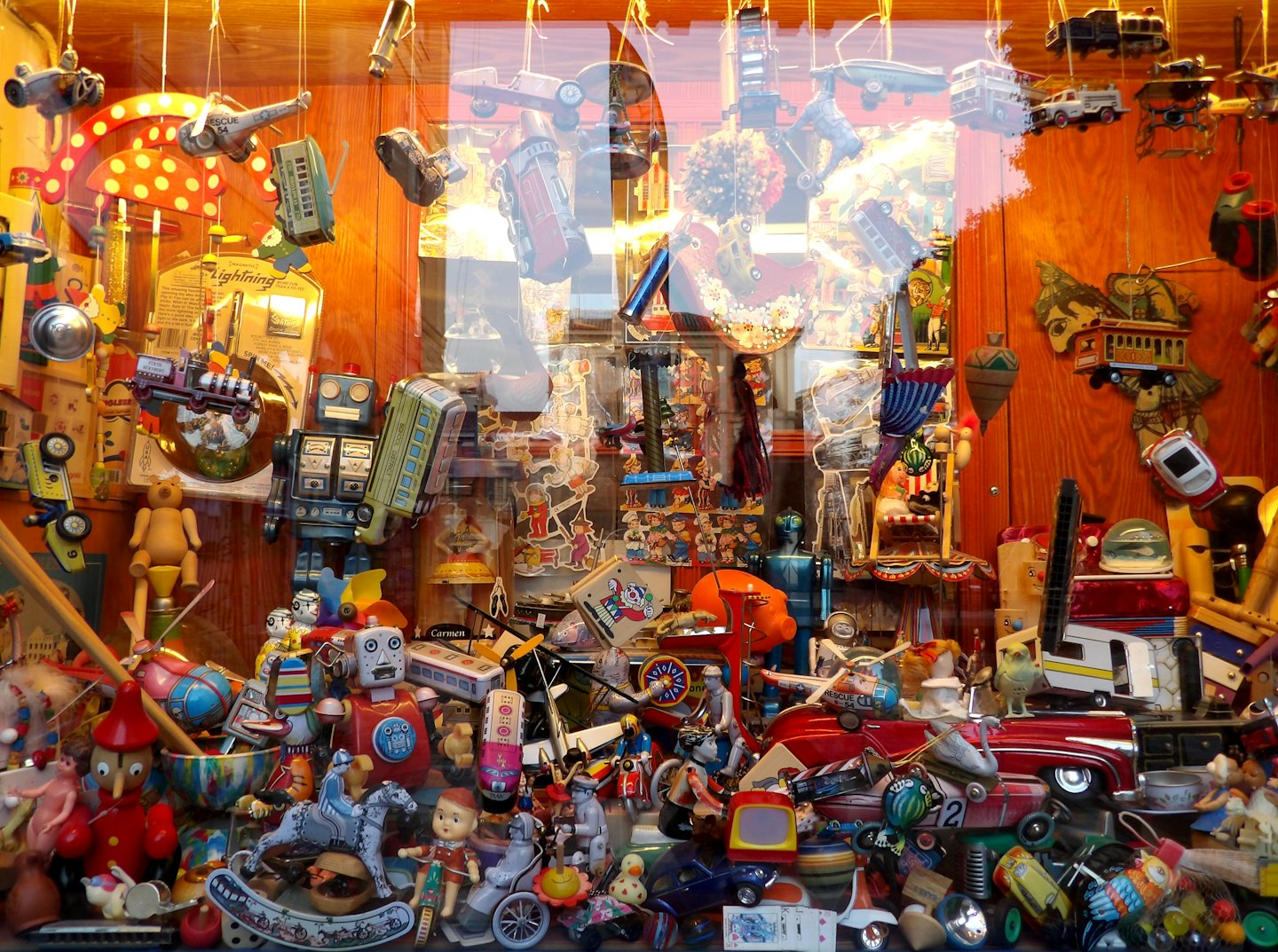 Vintage toys and collectibles displayed in a shop window.